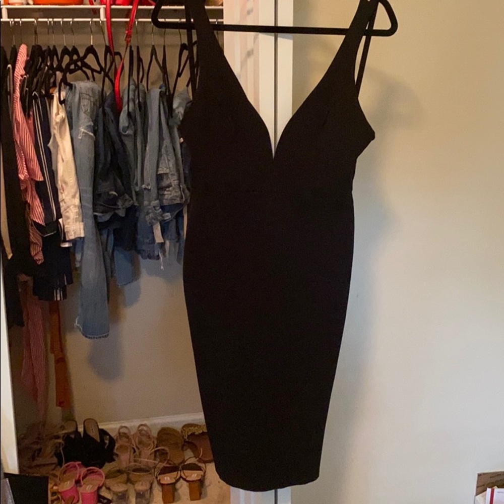 Black body hugging dress with plunge neckline